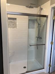 White Subway Tile Shower With Carrara Marble Herringbone Tiled Niche White Subway Tile Shower Onyx Shower Bathroom Design