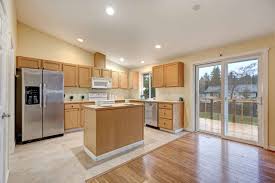 Amazing kitchen features a white shaker cabinets paired with gray quartzite countertops fitted with a curved stainless steel sink and a white subway tiled backsplash. Installing Upper Cabinets On An Angled Ceiling Use These Tips Upgraded Home