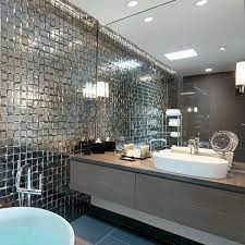 The rough brick wall and unfinished wood table of this space contrast with the smooth, geometrical look of the washbasin and mirror. Bathrooms By Design Quality Bathroom Design Cheshire Bathrooms By Design