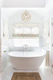 And since they come in a variety of styles, you're sure to find one that best fits your home's aesthetic. Freestanding Bathtub Nook With Rope Chandelier Transitional Bathroom