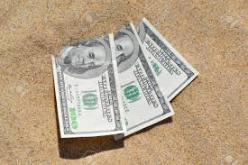 4104842,85 y el € a bs. Money Dolars Half Covered With Sand Lie On Beach Close Up Dollar Bills Partially Buried In