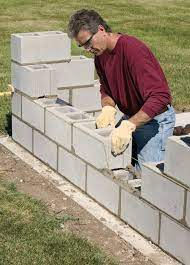 Whether you're building a retaining wall or just need some extra privacy, a cinder block wall is an affordable way to get the job done. How To Build A Concrete Wall For Your Own Private Backyard Retreat Better Homes Gardens