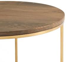 Angled legs are simple, yet striking—while its planked mango wood top is anything but ordinary. Delaney 25 Round Coffee Table Pottery Barn