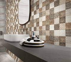 We love this bathroom from charlie interior design that features a tiled floor and wall with gray and white tiles that are just different enough to create delineation. Bathroom Tile Designs