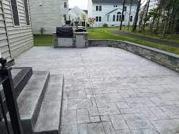 The average cost to pour a concrete patio is $2,433, with most homeowners paying $1,212 to $4,318 for professional installation. R Stamped Concrete Patio Seating Wall With Flagstone Caps And Dropped In Grill Traditional Patio Other By Haijoe Stamped Concrete Patios And Decks Houzz