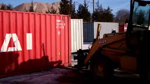 Detaching & lifting a shipping container from a tractor trailer. How To Move A Shipping Container With A Back Hoe Youtube