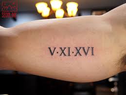 Roman Numeral Tattoo on Inner Upper Arm