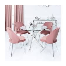 A rustic dining room is made more modern with a glass top dining table and a glam dining space with metallic sphere pendant lamps, a brass table base and a round tabletop, comfy cream chairs. Round Glass Dining Table 4 Pink Velvet Chairs Aurora Boutique Furniture123