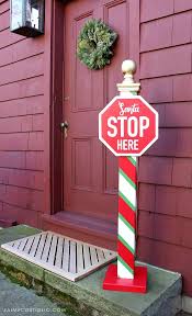 Christmas stop sign with santa stop here across the center and lights along the border. Diy Santa Stop Here Post Free Plans Jaime Costiglio Diy Christmas Yard Signs Christmas Yard Decorations Christmas Decorations Diy Outdoor