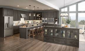 The grey cabinets certainly look at home here thanks to the similarly colored backsplash tiles and kitchen wall. New Cherry Slate Is Inspired By The Beauty Of Time Weathered Nature It Is A Dark Charcoal Gray That Kitchen Cabinet Styles Slate Kitchen New Kitchen Cabinets