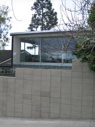 Retaining walls can be a great way not only to help with erosion and water drainage, but also to create beautiful, usable garden space. Benson Rd Remuera Remodelling Of Tired 70s Home Vertical Toungue In Groove Weatherboard Flat Ish Long Run R Brick Feature Wall Exterior Brick House Exterior