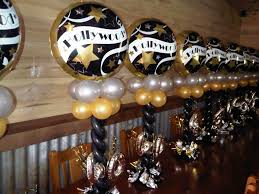 Description balloon columns with a clapboard and film reel shaped balloon on top added to the festivities of this hollywood themed event. 22 Hollywood Ideas Hollywood Theme Balloon Decorations Balloons