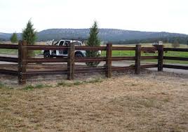 Round pressure treated wooden fence posts plant stakes with a pointed end. Wooden Pole Fence The Fence Building A Fence Pergola Fence Design