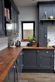 Charcoal Colored Cabinets Walnut Countertops And Black Grouted Subway Tiles Give This Cozy K American Kitchen Design Kitchen Design Farmhouse Kitchen Cabinets