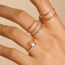 Check spelling or type a new query. Picture Of Thin Stacked Gold Rings With Diamonds And A Moonstone Are Different In Textures And Shapes And Create A Catchy Look