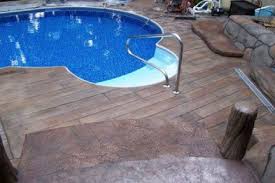 Swimming pool with blue water outdoor. Stamped Concrete Wood Plank Texture Great Plains Concrete