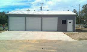 Custom 3 car garage with cedar shakes, cedar clapboard, and stone accents. 24x41x10 3 Car Garage