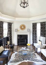 Black and gold living room features a glossy black and gold cocktail table atop a furry sheepskin rug facing a white tv cabinet fitted with sliding gold white and gold powder room boasts walls clad in gold ikat wallpaper, phillip jeffries indo ikat camel and tan wallpaper, lined with a mirror illuminated. Black White And Gold Home Decor House Decoration Items