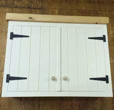 Simple white cabinets and clean silver hardware work well alongside wooden countertops and light colored wall paint. White Planking Farmhouse Style Cabinet With Contrast Black Tee Hinges Farmhouse Cabinets Hinges For Cabinets Cabinet Styles
