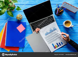 Close View Person Studying Charts Laptop Blue Wooden Table