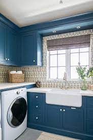 Our laundry room ideas will help you create an organized space for you and your family. Bold Blue Laundry Room Cabinets With Farm Sink Cottage Laundry Room