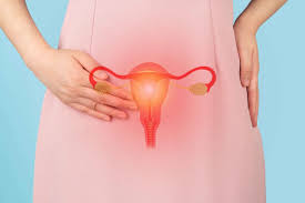 Person with hand on lower abdomen and overlay of female reproductive organs, representing menstrual disorders