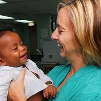 US Navy 070623-N-7088A-036 Capt. Wanda Richards and Chief Hospital Corpsman  Tracey Lewis play with a young child in a playroom aboard the Military  Sealift Command hospital ship USNS Comfort (T-AH 20) -