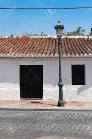 The vibrant blue front door creates authentic charm and notice the tiled roof what do you call this style? Front Side Of Typical Spanish House Stock Photo Picture And Royalty Free Image Image 30113224