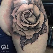 A rose tattoo doesn't have to be a vibrant red to have an impact. Black And Gray Rose Tattoo By Capone Tattoonow Rose Tattoo Design Tattoo Designs Black Rose Tattoo Meaning
