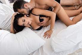 Sexy Man Kissing Hair And Touching Breast Of Passionate Woman In Bed Stock  Photo, Picture and Royalty Free Image. Image 162034056.
