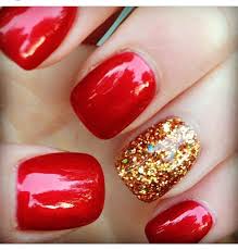 Red Nails Golden Glitter Accent Fmag Com Use a gold glitter nail polish for one of your nails if you want this design to look stunning.