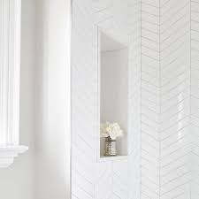 This is such a clean look yet comforting at the same time. White Chevron Tile With Arctic White Grout Creates A Super Bright On Trend Look Bathroomtiles Chevron Tile White Tile Shower Chevron Bathroom