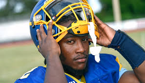 Who is the Herald-Tribune first half football player of the year?