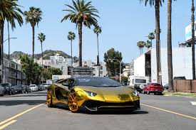 A project that was initially going to be a printed design wrap changed course when our client took a second glance at the color options we offered. Chris Brown S Gold Lamborghini Aventador Sv Roadster On Forgiato Wheels