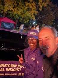A giant yellow banner draped across a brick building in East Durham has  been turning heads and sparking speculation for weeks. “HE'S COMING,” it  reads in bold black letters, with a circular