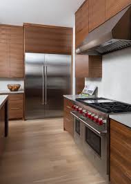 Cohesive design and modern accents add just the refined finesse you're envisioning for a contemporary kitchen designed to stun. Modern Kitchen With Flat Front Walnut Cabinets And Stainless Steel Appliances Hgtv