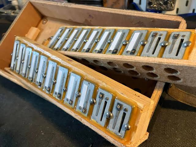 Old accordion reed plates showing leather valves