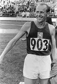 Zatopek crosses the line in the 5,000m. Emil Zatopek