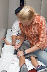 US Army (USA) Sergeant (SGT) Danielle Sierra, a Licenced Practical Nurse  (LPN), gives a Hepatitis A vaccination to a young Georgian (GEO) boy at a  hospital in the town of Marneuli, Georgia (