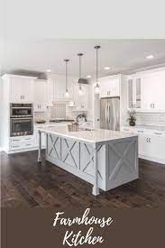 I Love The Island Bar In This Farmhouse Kitchen With The Glass Pendant Lights Hanging Above The Subway Tile Add Modern Farmhouse Kitchens Home Remodeling Home
