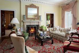 The drawing room might have had pale blues, with stencilled or painted rush and grass designs. Chintz English Country Style Drawing Room Persian Rug Fireplace The Glam Pad