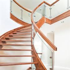 In this case, the glass wall adjacent to the stairs, reinforces this. Contemporary Curved Staircase Design With Prefabricated Stainless Steel Standoffs Tempered Glass Railing