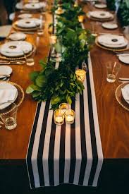 Gold votive candle holders are the perfect combination of elegance and class. Black And White Striped Runner With Greenery And Gold Votive Candle Holders Wedding Inspiration Board Junebug Weddings