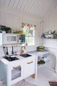 Kids cubby house playhouse with blackboard and mud kitchen and bench inside. 30 Jaw Dropping Playhouse Ideas Momooze Com