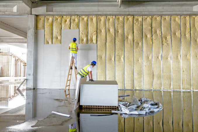 Interior room with fresh drywall installed on the walls and ceiling