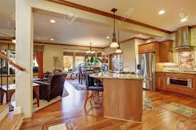 Learn how to decorate a living room with an open floor plan using our tips on linking different areas, defining zones, and establishing a distinct style within open spaces. Open Floor Plan Interior With Living Room Kitchen And Dining Area Hardwood Floor And Leather Armchairs Stock Photo Picture And Royalty Free Image Image 60403726