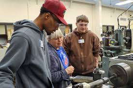TCAT Dickson Automotive Technology students Aiden Sanders (green shirt),  Juan Perez (left) and Dawson Huggins (back) are practicing their  troubleshooting skills by testing the spark plugs and coil packs