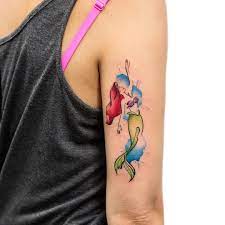 We have ariel tattoo ideas, designs, symbolism and we explain the meaning behind the tattoo. Small Watercolor Ariel Tattoo Little Mermaid Tattoos Mermaid Tattoos Mermaid Tattoo