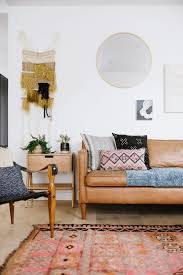 A Modern Boho Living Room With Vintage Rugs And A Safari Chair Concepts And Colorways Modern Boho Living Room Leather Couches Living Room Boho Living Room