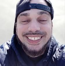 What song comes to mind when seeing an old picture of Tupac Shakur?